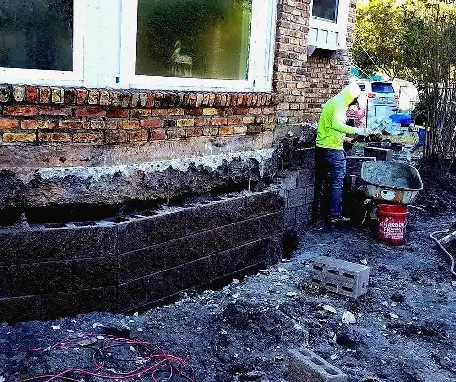 Worker rebuilding Foundation Repair Erie, PA