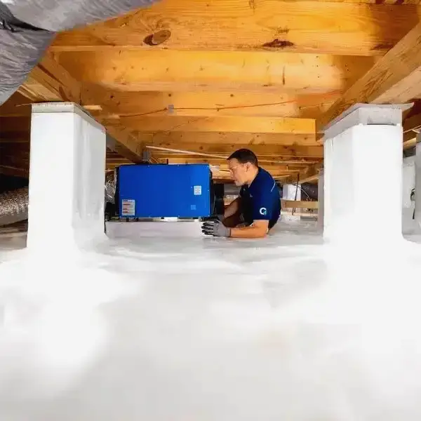 technician working in a crawl space encapsulation in Erie, PA